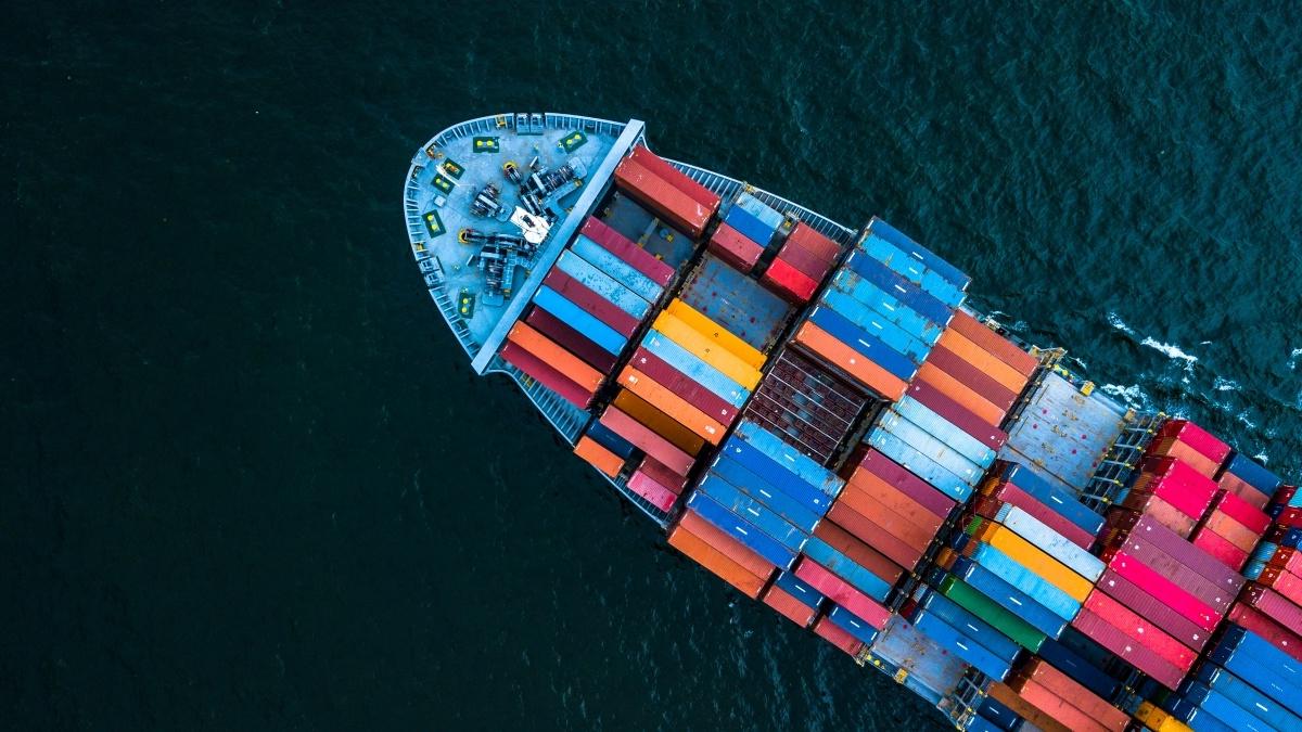 Top down view of container ship carrying cargo on the ocean