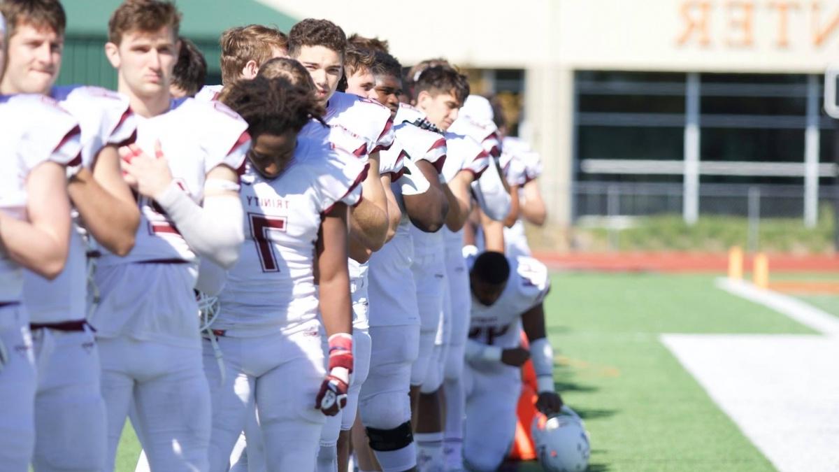 A Trinity football player kneeling for social justice
